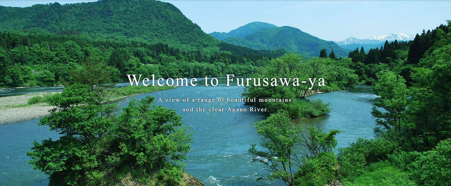 A view of a range of beautiful mountains and the clear Agano River.